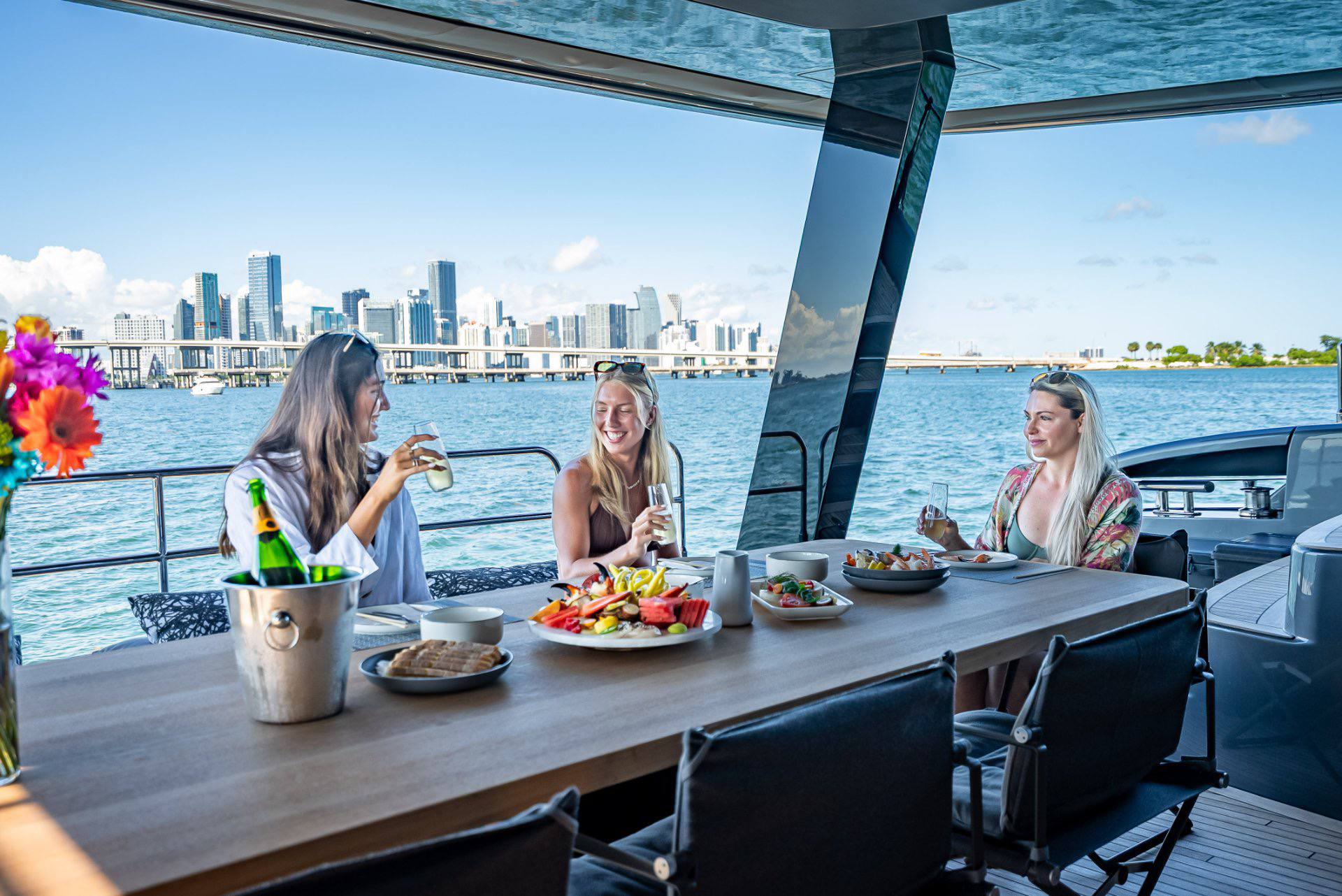Guests enjoying luxury yacht dining with Miami skyline views